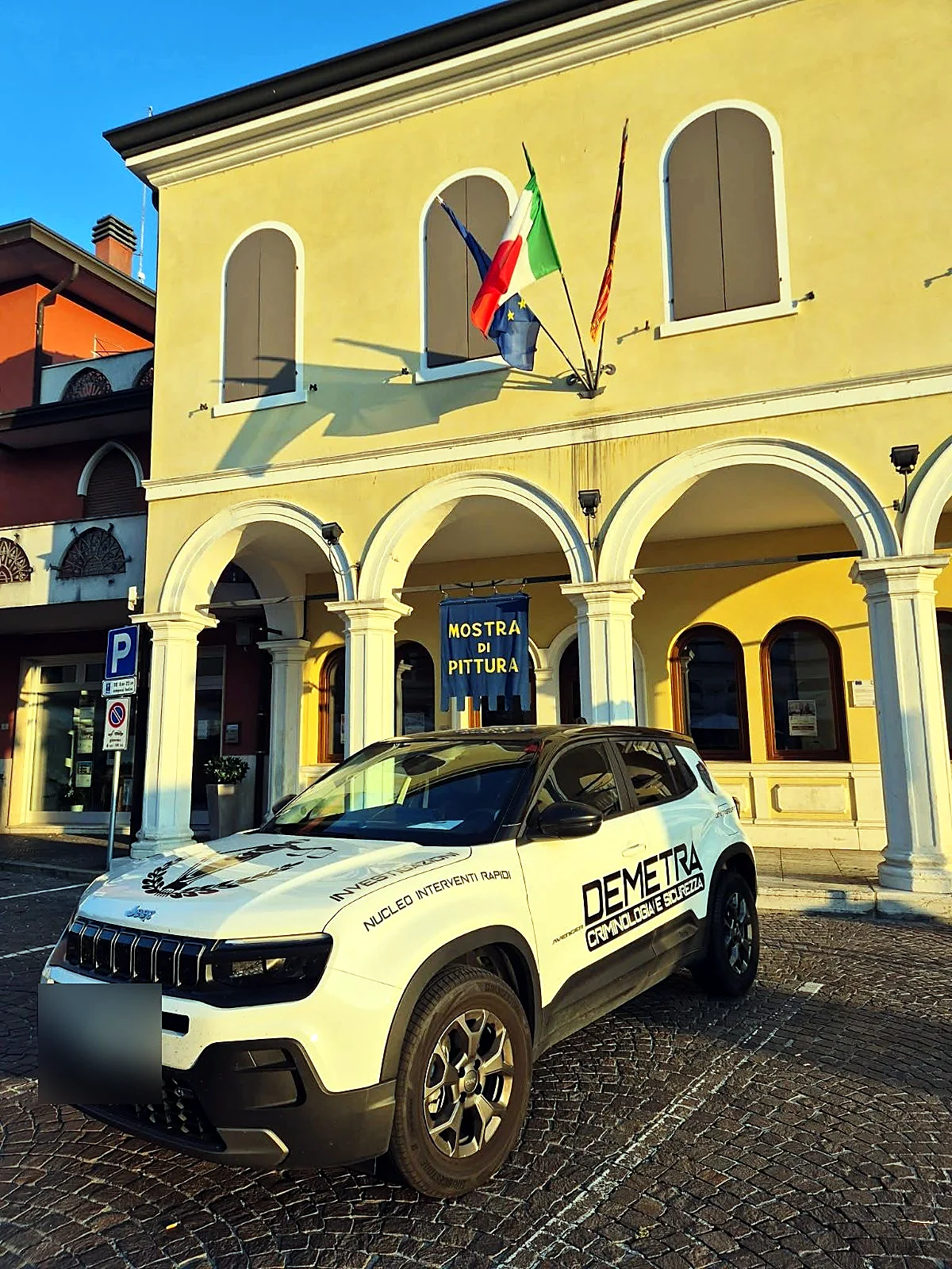 Demetra Group company car in front of an arcaded building